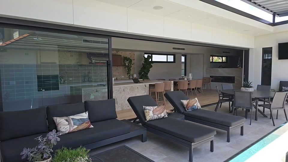 Automated sliding doors connecting the finished Merewether home with its courtyard and poolside terrace